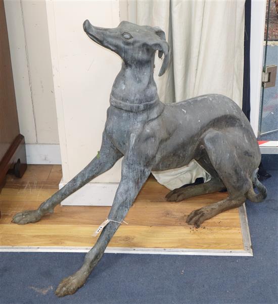 A bronze garden ornament of a seated greyhound